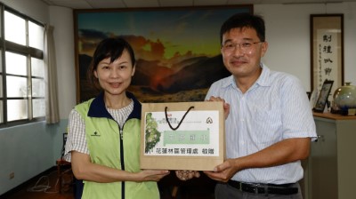 花蓮林區管理處秘書余蘭君(左)代表將圖書贈與中原國小，由校長干仁賢(右)代表接受。